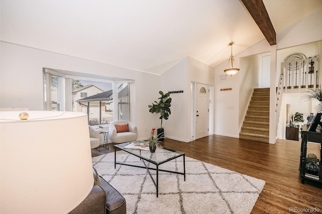 living room with vaulted ceiling with beams, stairs, baseboards, and wood finished floors