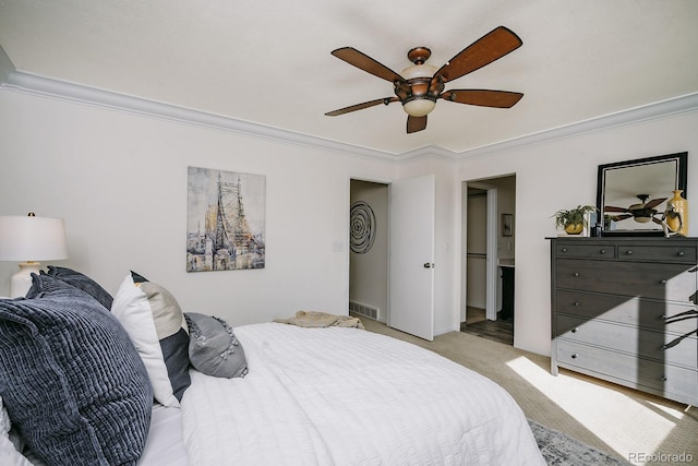 bedroom featuring visible vents, light colored carpet, and ornamental molding