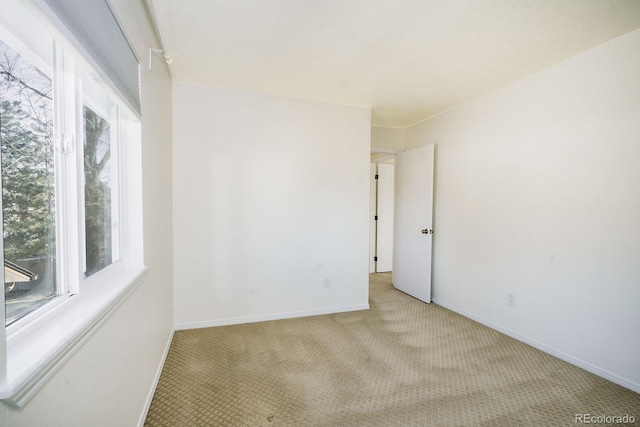 unfurnished room featuring carpet flooring and baseboards