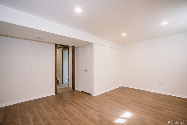 unfurnished room featuring visible vents, baseboards, stairway, recessed lighting, and wood finished floors