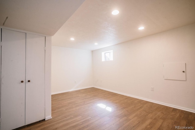 below grade area featuring recessed lighting, baseboards, and wood finished floors