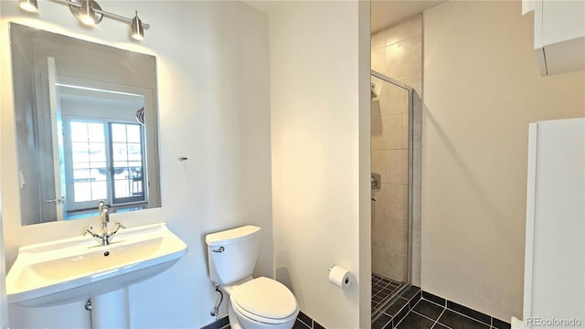 bathroom featuring sink, tile patterned floors, toilet, and a shower with door