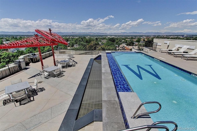 view of swimming pool with a patio