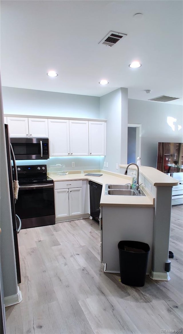 7355 S Alkire St Unit 203, Littleton, CO 80127 - kitchen featuring stainless steel appliances, light wood-type flooring, white cabinetry, and recessed lighting