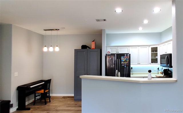 7355 S Alkire St Unit 203, Littleton, CO 80127 - kitchen with freestanding refrigerator, a peninsula, white cabinetry, glass insert cabinets, and recessed lighting