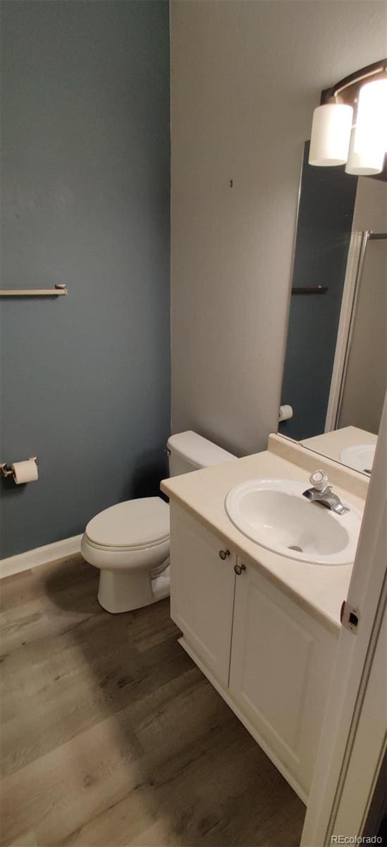 7355 S Alkire St Unit 203, Littleton, CO 80127 - bathroom featuring vanity and wood finished floors