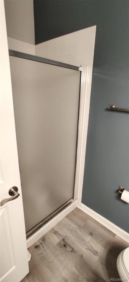 7355 S Alkire St Unit 203, Littleton, CO 80127 - bathroom with a stall shower and wood finished floors