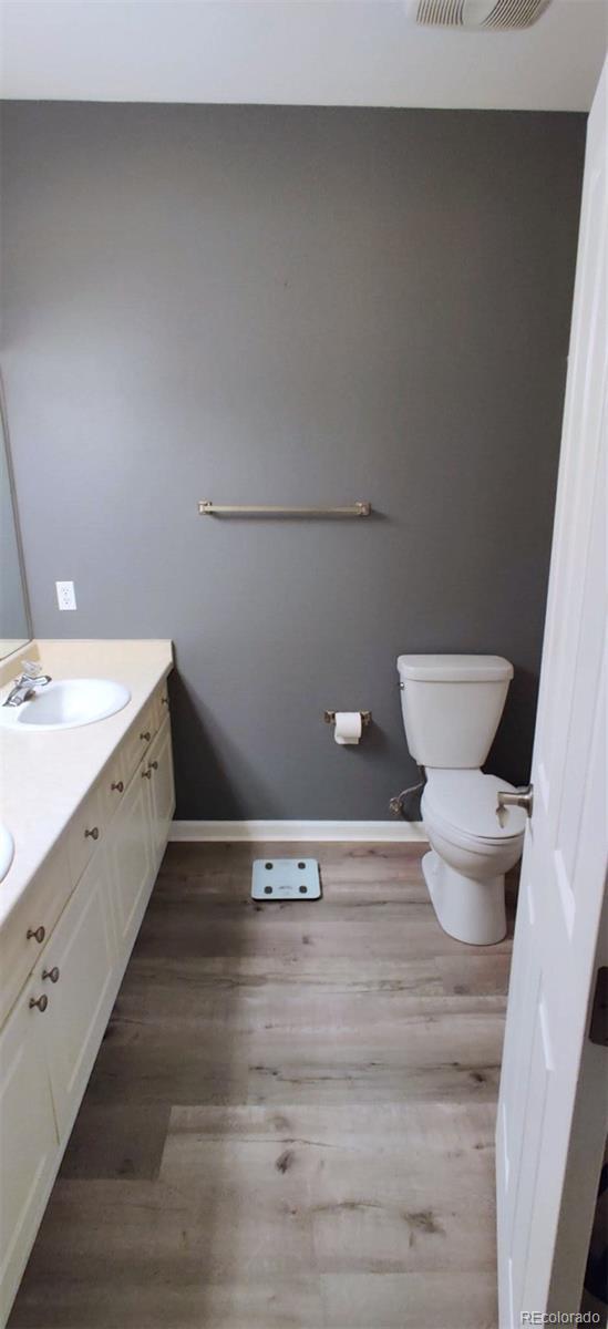7355 S Alkire St Unit 203, Littleton, CO 80127 - bathroom featuring vanity and wood finished floors