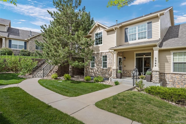 5944 S Yank Ct, Littleton, CO 80127 - view of front of property featuring stone siding, a front yard, stairway, and a porch