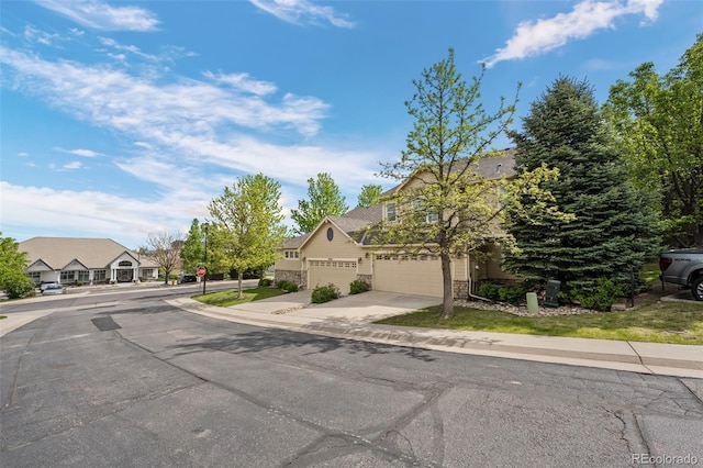 5944 S Yank Ct, Littleton, CO 80127 - view of asphalt road featuring sidewalks, traffic signs, curbs, and a residential view