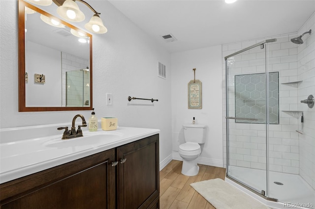 5944 S Yank Ct, Littleton, CO 80127 - bathroom featuring a stall shower, wood finished floors, and toilet