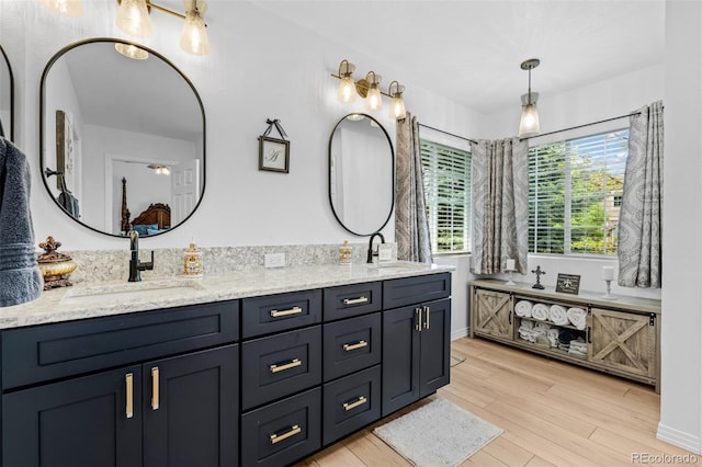 5944 S Yank Ct, Littleton, CO 80127 - bathroom featuring wood finished floors and double vanity