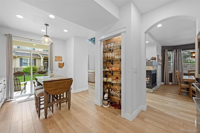 5944 S Yank Ct, Littleton, CO 80127 - dining area with arched walkways, light wood finished floors, baseboards, and recessed lighting