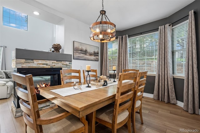 5944 S Yank Ct, Littleton, CO 80127 - dining area with light wood-style floors, a chandelier, a fireplace, baseboards, and recessed lighting