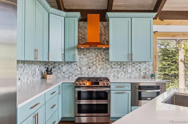 142 High Point Dr, Breckenridge, CO 80424 - kitchen with appliances with stainless steel finishes, wall chimney exhaust hood, light countertops, tasteful backsplash, and beamed ceiling