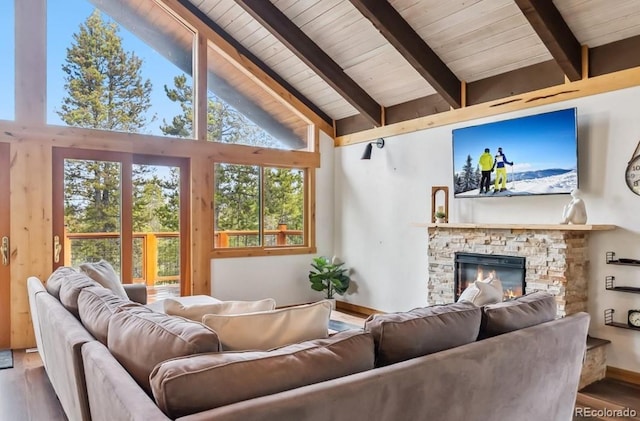 142 High Point Dr, Breckenridge, CO 80424 - living room with wood finished floors, high vaulted ceiling, beamed ceiling, a stone fireplace, and plenty of natural light