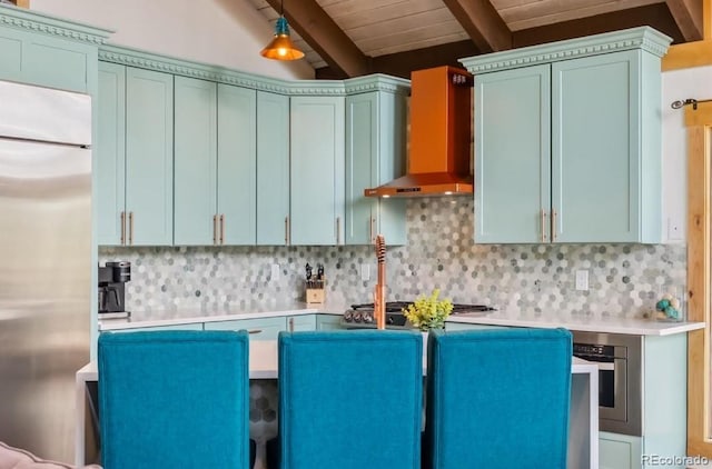 142 High Point Dr, Breckenridge, CO 80424 - kitchen with stainless steel appliances, wall chimney exhaust hood, beam ceiling, light countertops, and backsplash