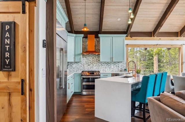 142 High Point Dr, Breckenridge, CO 80424 - kitchen with stainless steel appliances, a sink, wall chimney exhaust hood, a peninsula, and backsplash