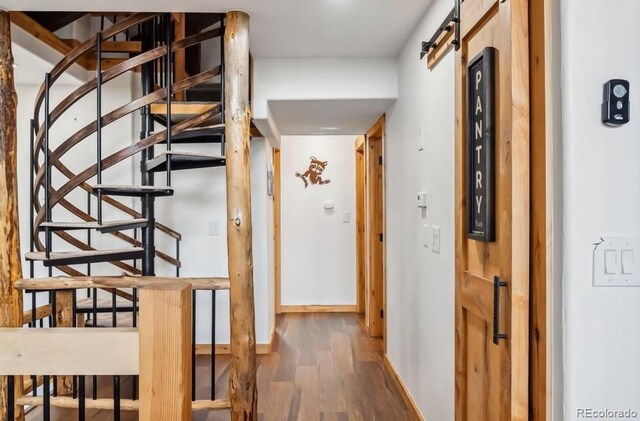 142 High Point Dr, Breckenridge, CO 80424 - staircase featuring wood finished floors and a barn door