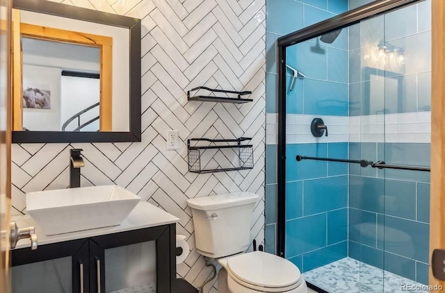 142 High Point Dr, Breckenridge, CO 80424 - full bathroom featuring tile walls, a stall shower, toilet, and vanity