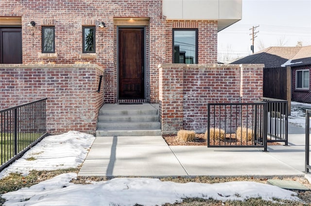 view of snow covered property entrance