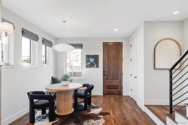 dining space with breakfast area and dark wood-type flooring