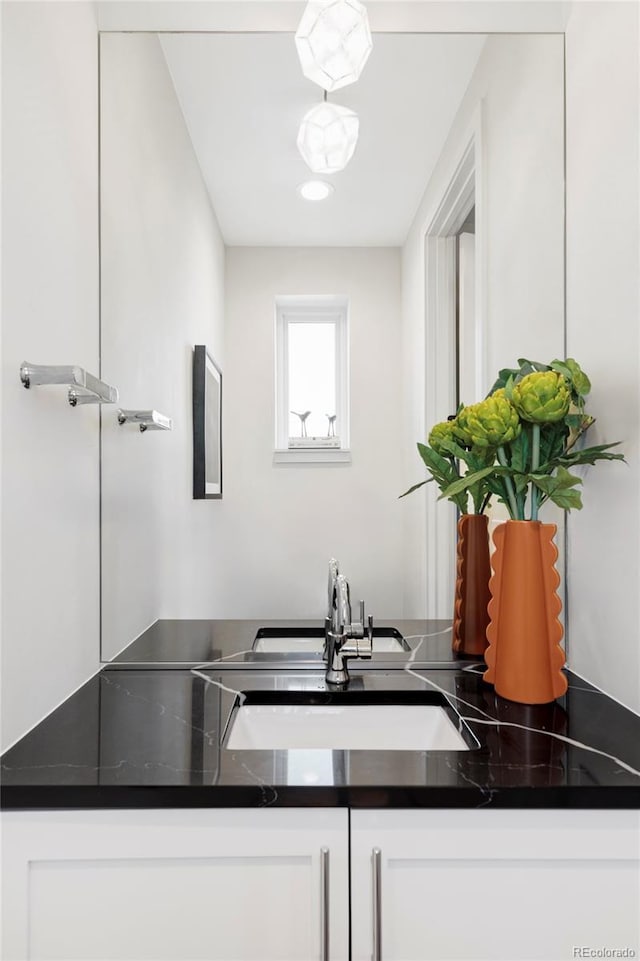 kitchen featuring sink and white cabinetry