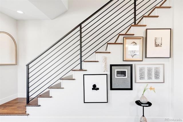 staircase with hardwood / wood-style floors