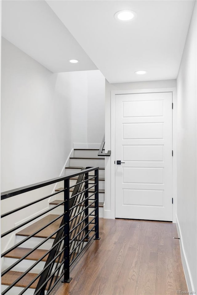 corridor with hardwood / wood-style floors