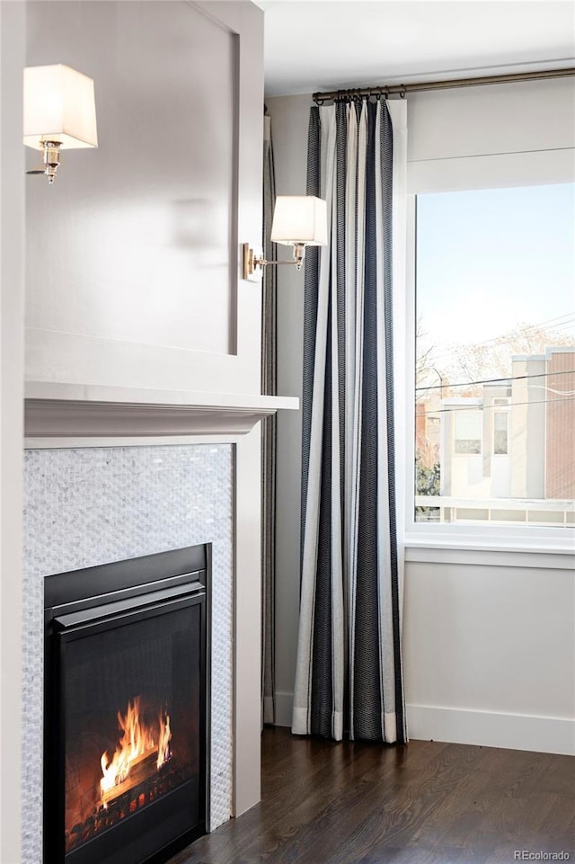 details featuring a tile fireplace and hardwood / wood-style floors