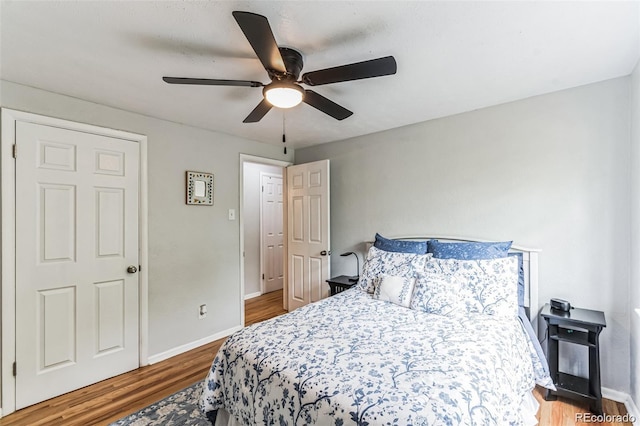 bedroom with hardwood / wood-style floors and ceiling fan