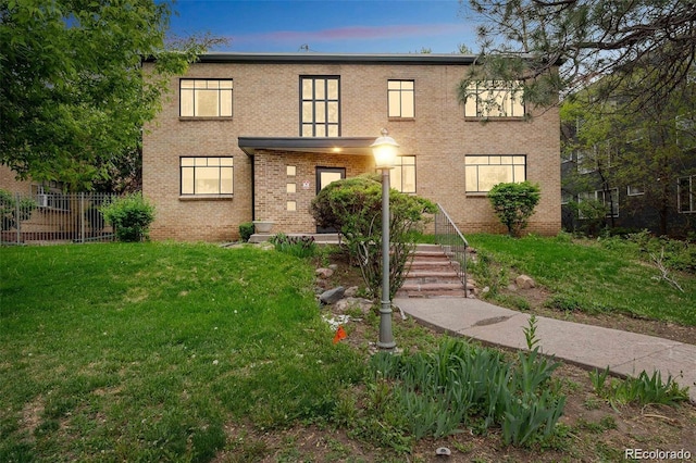 view of front of property with a lawn