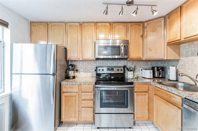 kitchen featuring appliances with stainless steel finishes and light brown cabinets