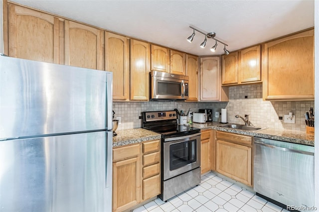 kitchen featuring sink, decorative backsplash, light brown cabinets, and appliances with stainless steel finishes