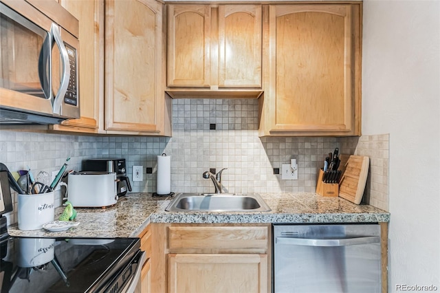 kitchen featuring backsplash, appliances with stainless steel finishes, sink, and light brown cabinets