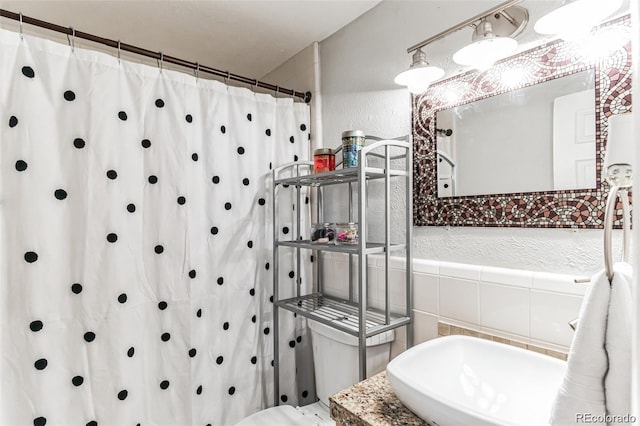 bathroom with tile walls and a shower with curtain