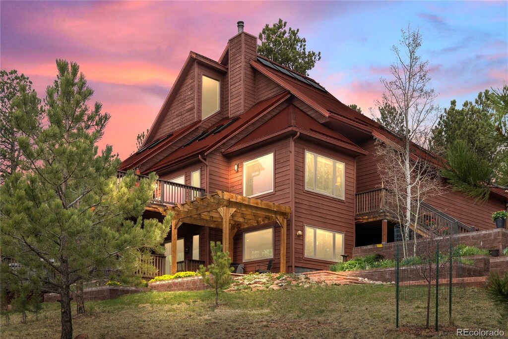 665 Meadow Dr, Pine, CO 80470 - rear view of property with a chimney, a deck, and a yard