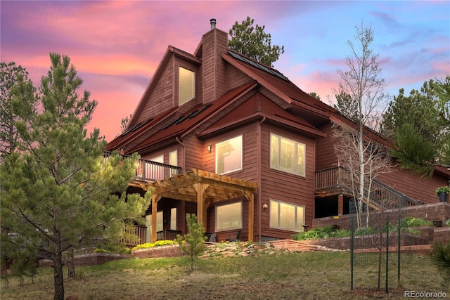 665 Meadow Dr, Pine, CO 80470 - rear view of property with a chimney, a deck, and a yard