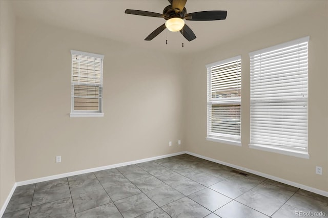 unfurnished room with ceiling fan and light tile patterned floors