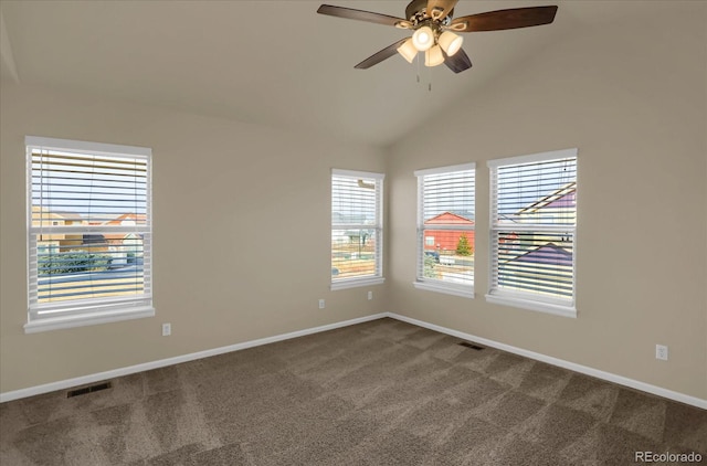 carpeted spare room featuring ceiling fan, plenty of natural light, and vaulted ceiling