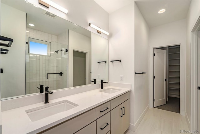 bathroom with vanity, an enclosed shower, and tile patterned floors