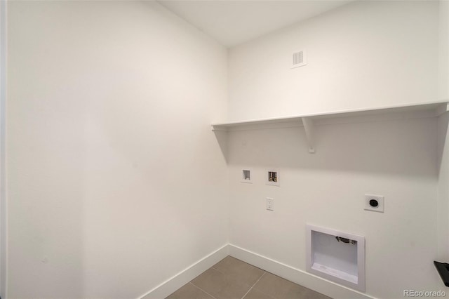 washroom with hookup for an electric dryer, hookup for a washing machine, and light tile patterned floors