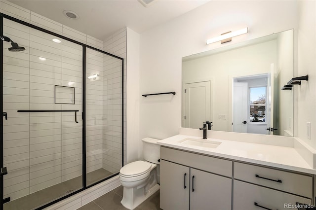 bathroom featuring walk in shower, tile patterned flooring, vanity, and toilet