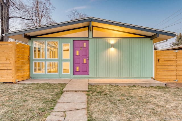 rear view of property featuring a yard