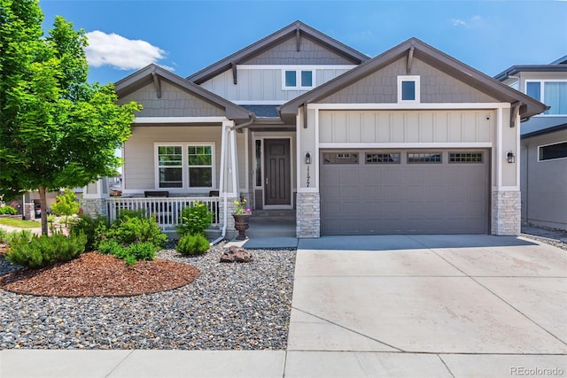 1177 Man O War Way, Colorado Springs, CO 80921 - craftsman inspired home with a garage, covered porch, driveway, stone siding, and board and batten siding