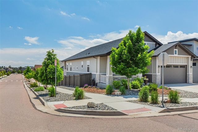1177 Man O War Way, Colorado Springs, CO 80921 - view of front of home with an attached garage, stone siding, driveway, and board and batten siding