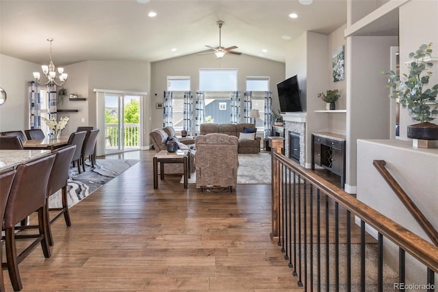 1177 Man O War Way, Colorado Springs, CO 80921 - living room with ceiling fan, a chandelier, vaulted ceiling, a fireplace, and wood finished floors