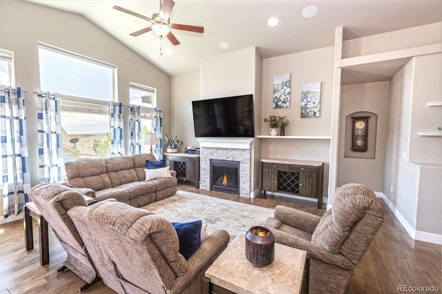 1177 Man O War Way, Colorado Springs, CO 80921 - living area with wood finished floors, a ceiling fan, vaulted ceiling, a fireplace, and recessed lighting