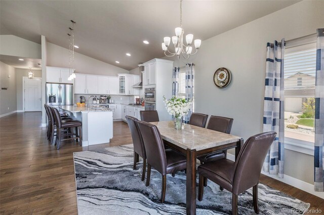 1177 Man O War Way, Colorado Springs, CO 80921 - dining area featuring vaulted ceiling, a chandelier, dark wood-type flooring, and recessed lighting