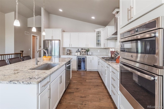 1177 Man O War Way, Colorado Springs, CO 80921 - kitchen with appliances with stainless steel finishes, beverage cooler, dark wood-style floors, white cabinetry, and recessed lighting